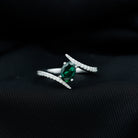 Rosec Jewels-Oval Shape Lab Grown Emerald Solitaire Bypass Ring with Moissanite