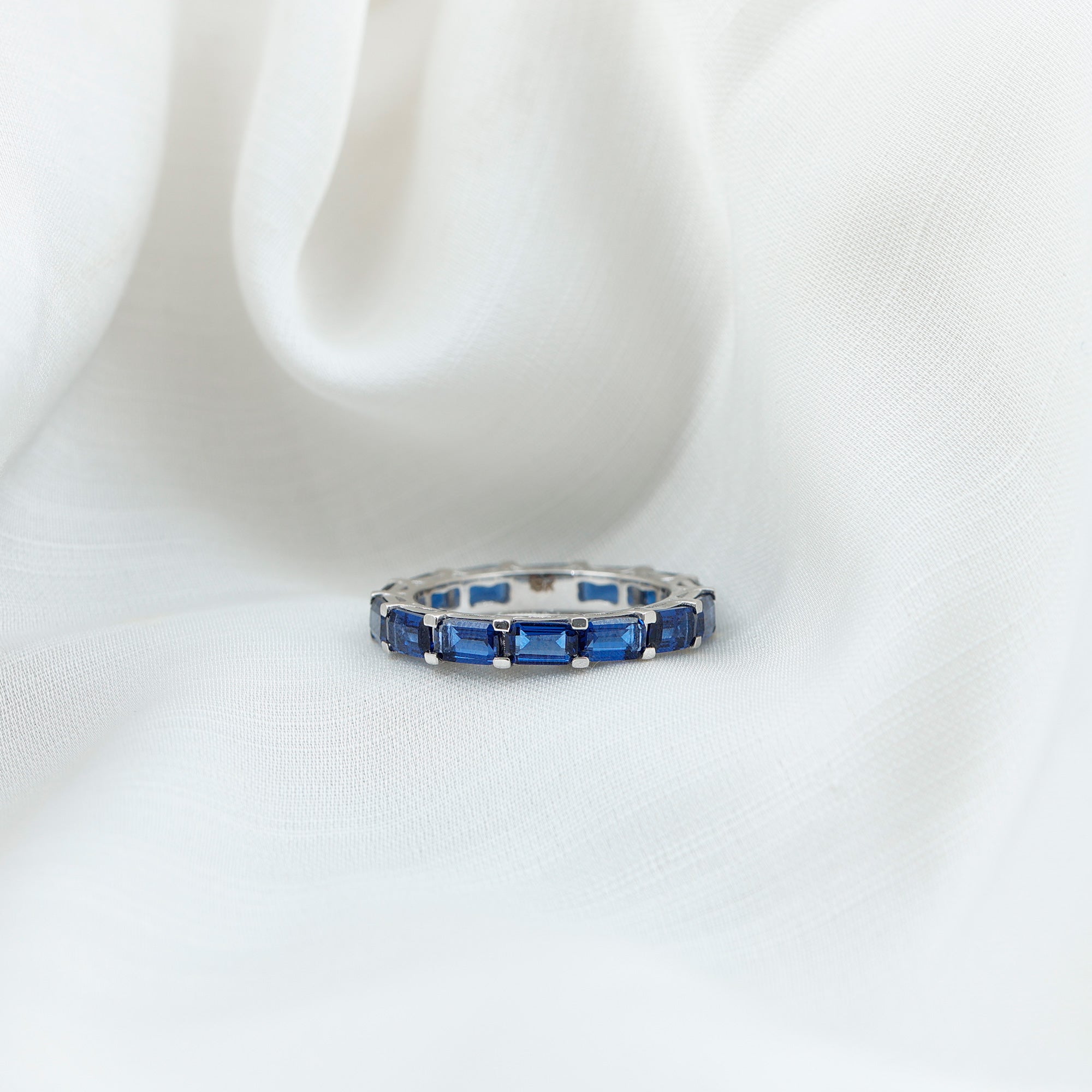 Rosec Jewels-7.75 CT Emerald Cut Created Blue Sapphire East West Eternity Ring